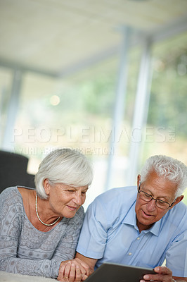 Buy stock photo Senior couple, tablet and reading in home for ebook, online banking and memory app at space. Elderly people, tech and relax in living room with connectivity, retirement research and ecommerce website