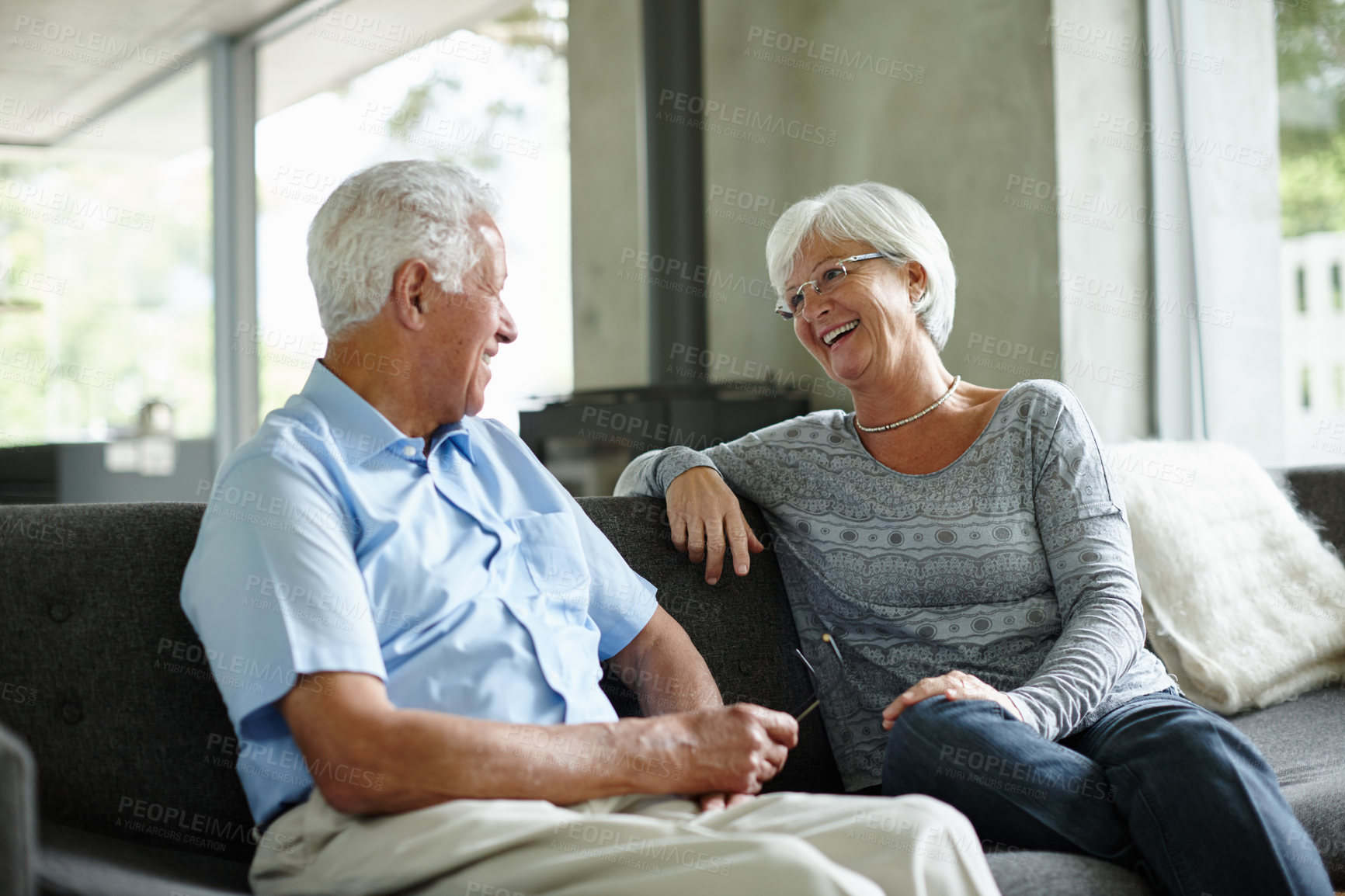 Buy stock photo Shot of a senior couple sitting in their living room