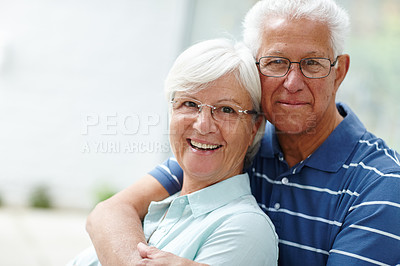 Buy stock photo Shot of a happy senior couple smiling at the camera