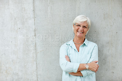 Buy stock photo Portrait of a senior woman standing with her arms crossed