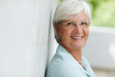 Buy stock photo Portrait of a senior woman smiling at the camera