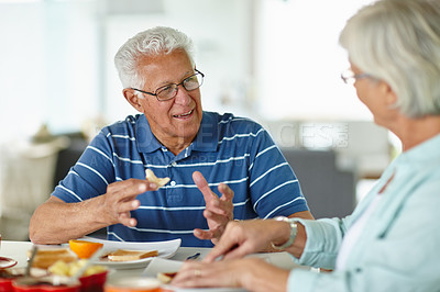 Buy stock photo Cropped shot of a senior couple eating breakfast