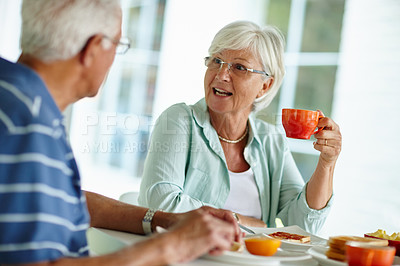 Buy stock photo Cropped shot of a senior couple eating breakfast