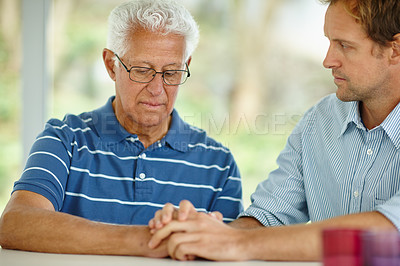 Buy stock photo Shot of a son comforting his senior father