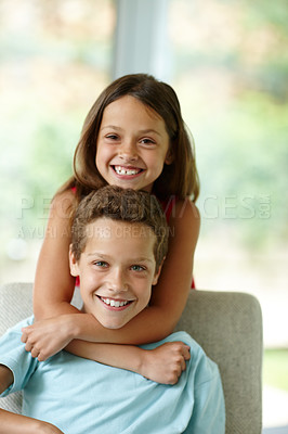 Buy stock photo Shot of a little girl embracing her brother from behind