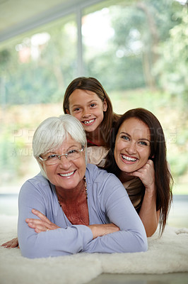 Buy stock photo Portrait of little girl lying on the carpet with her mother and grandmother