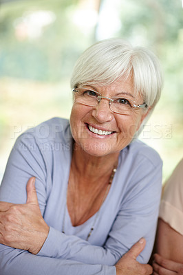 Buy stock photo Portrait of an attractive senior woman relaxing at home
