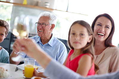 Buy stock photo Shot of a happy multi-generational family having a meal together