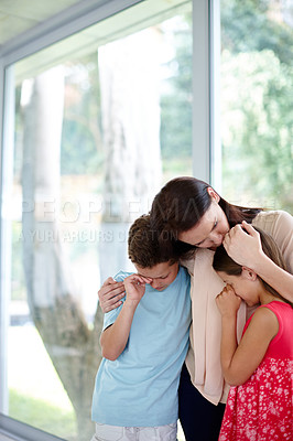 Buy stock photo Shot of a family supporting each other in their grief