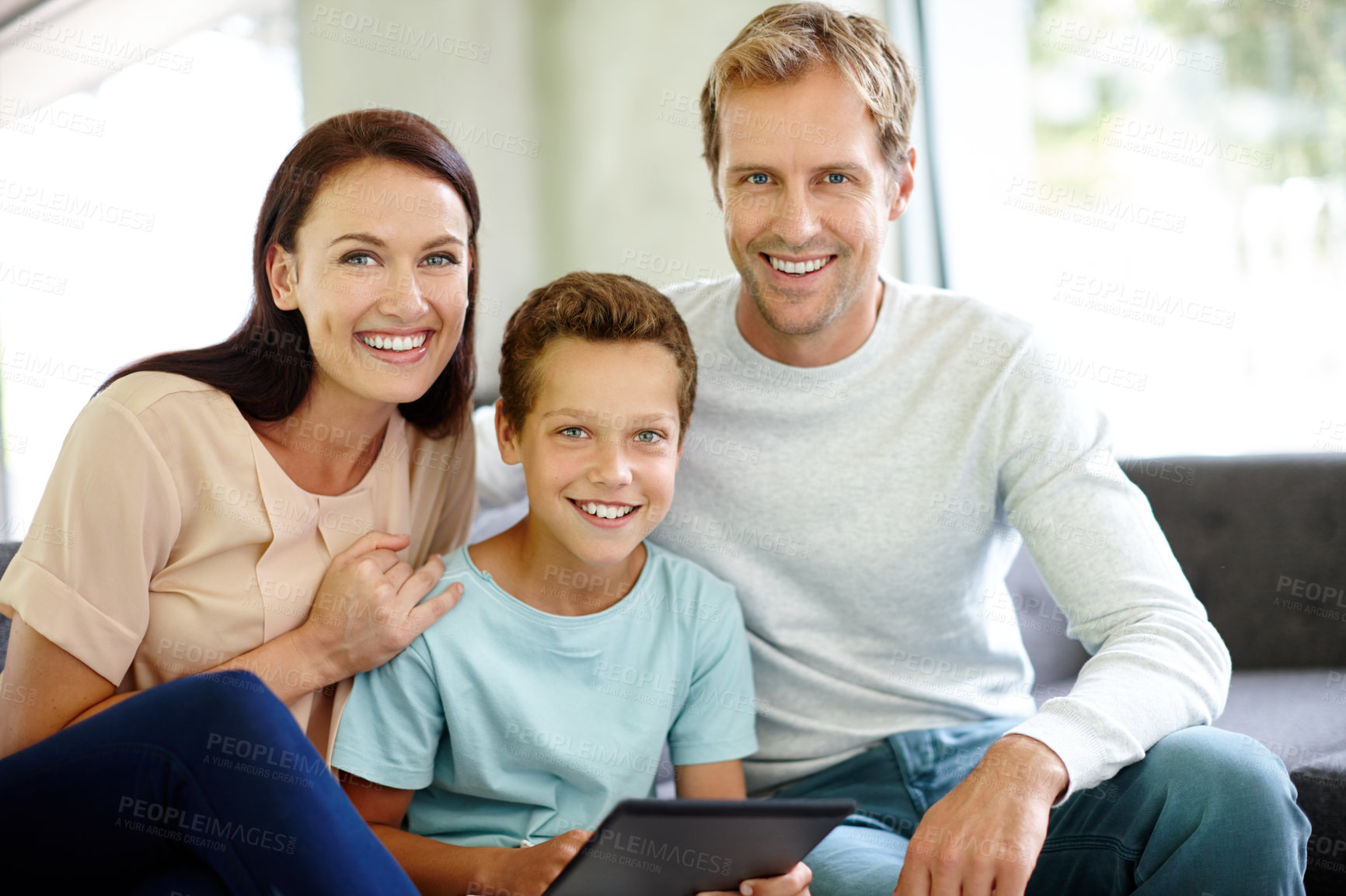 Buy stock photo Portrait, boy or tablet with happy family on sofa in living room of home together for bonding. Smile, gaming or touchscreen with mother, father or child in apartment for online streaming in Australia