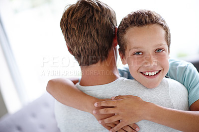 Buy stock photo Portrait of a happy little boy hugging his father at home