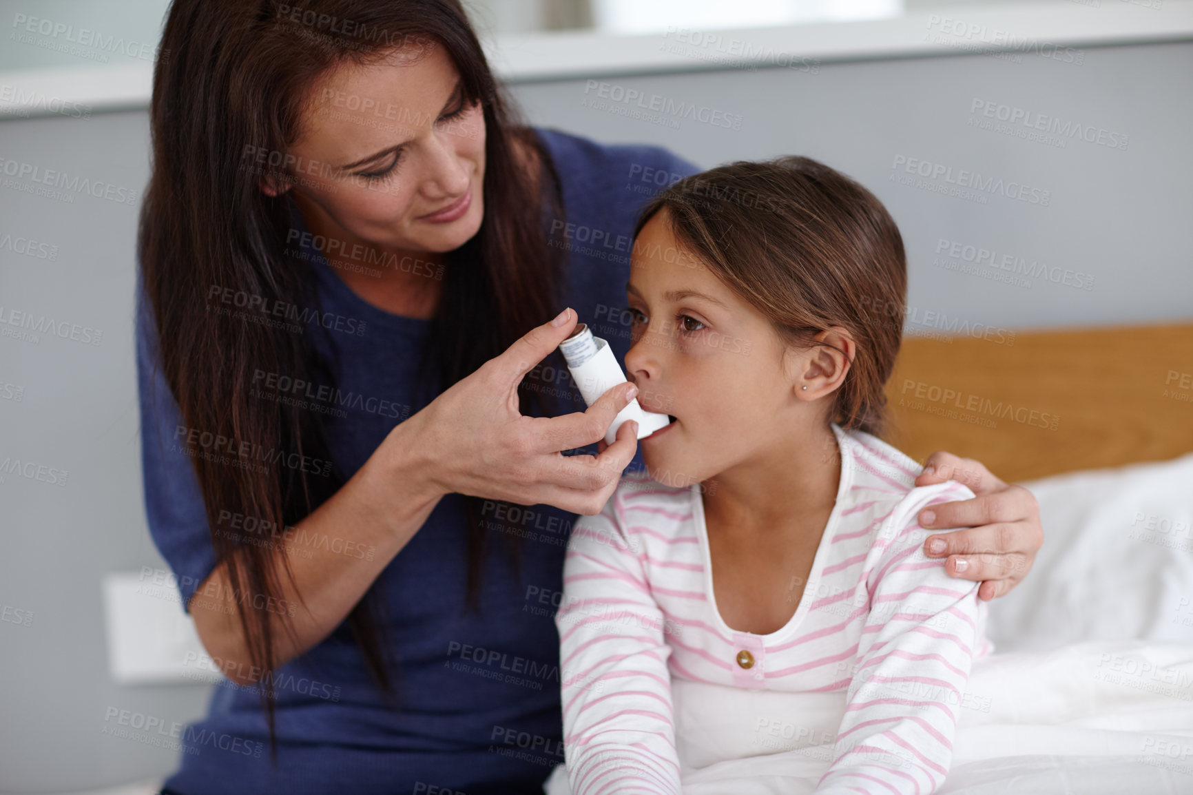 Buy stock photo Mother, girl or bed with inhaler for asthma, chronic disease or breathing air at home. Mom, daughter or sick child with pump for medicine, medication or treatment for allergy, virus or blocked airway