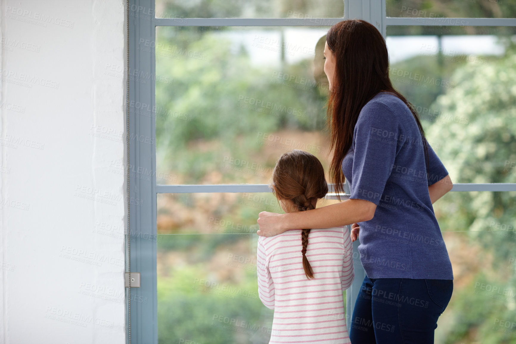 Buy stock photo Mother, daughter and window for view in home, curious child and bonding together on weekend. Mama, girl and back of family for security in relationship, love and conversation on garden or nature