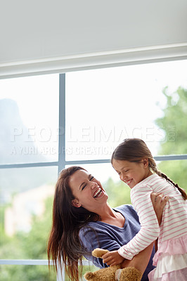 Buy stock photo Shot of a mother playing with her daughter at home