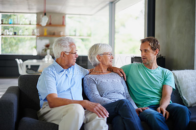 Buy stock photo Cropped shot of a senior couple sitting on the sofa with their son