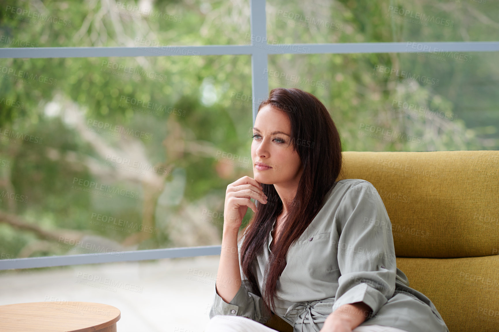 Buy stock photo A young woman relaxing in her living room