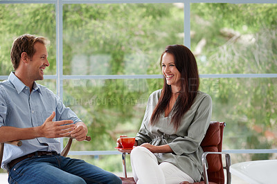 Buy stock photo A guy and his girlfriend talking in the living room