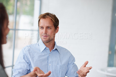 Buy stock photo A guy and his girlfriend talking in the living room