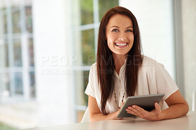 Buy stock photo Portrait of a woman sitting on her patio using a digital tablet