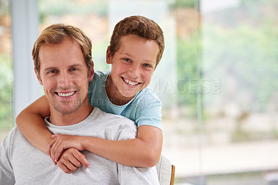 Buy stock photo Portrait of boy hugging his father