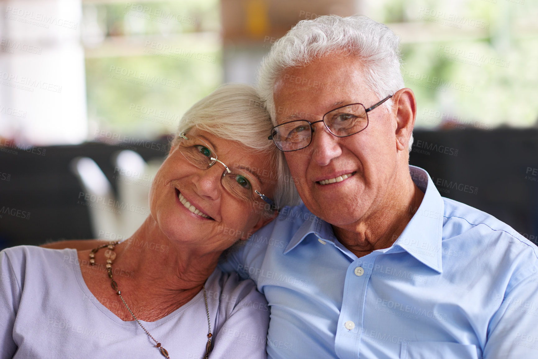 Buy stock photo Smile, portrait and senior couple on sofa with love, care or happy marriage in retirement together. Embrace, elderly man and woman on couch with support, relax or comfort in morning bonding in home
