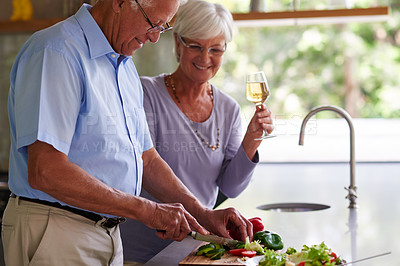 Buy stock photo Home, senior couple and cooking with food for cutting, bonding together and support for meal prep. Kitchen, man and woman with vegetables for wellness, dinner and nutrition with wine glass in house