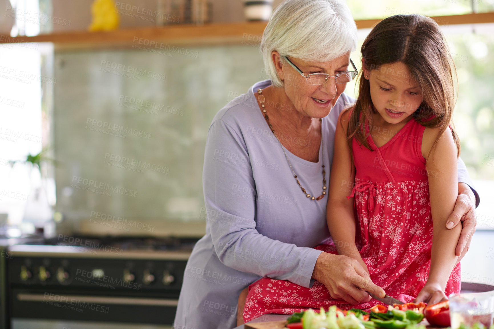 Buy stock photo Grandmother, kid and cutting vegetables in home, salad ingredients and cooking together. Grandma, grandchild and kitchen for food preparation or lunch, support and teaching instructions for meal