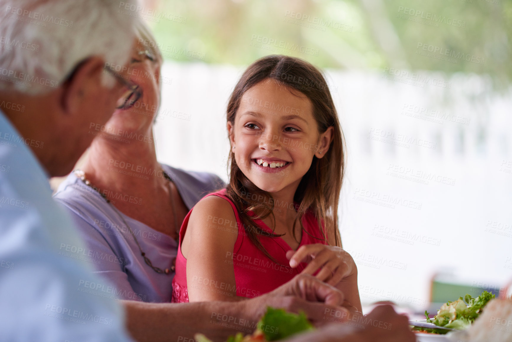 Buy stock photo Home, grandparents and child with food for dinner, brunch and bonding together as family with meal. Happy people, woman and man with girl for connection, nutrition and vegetables as healthy cuisine