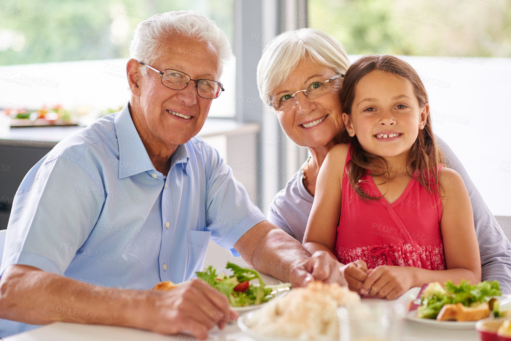 Buy stock photo Portrait of a little girl having lunch with her grandparents