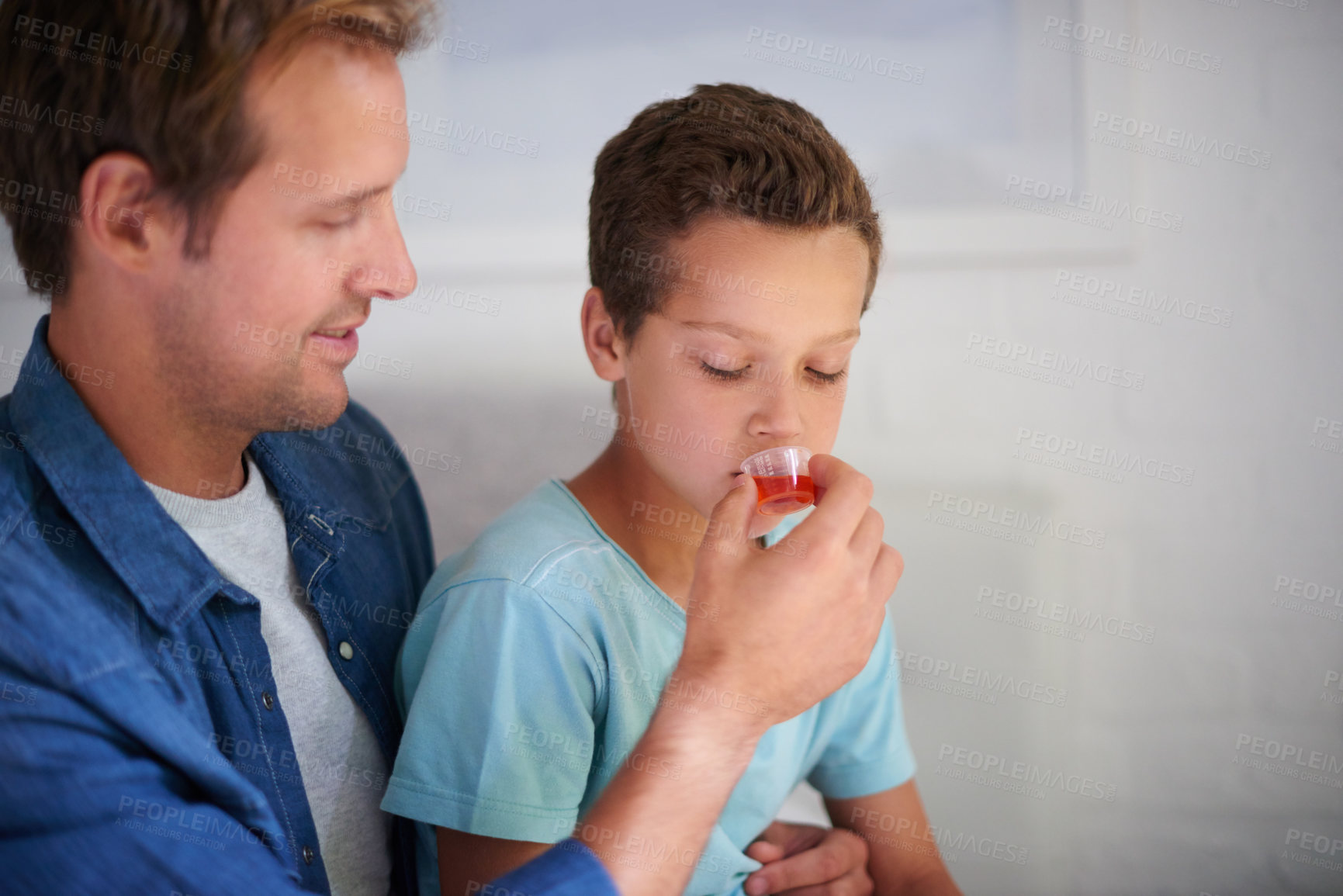 Buy stock photo Dad, sick child or medication with medicine for fever, pain relief or viral infection at home. Father, son or kid with liquid antibiotic or syrup for cough, cold flu or virus in bedroom at house