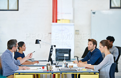 Buy stock photo Shot of a group of designers working at their computers in an office