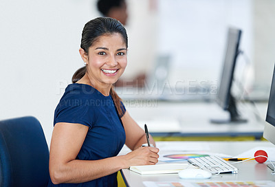 Buy stock photo Portrait of an attractive young designer sitting at her desk working on a computer