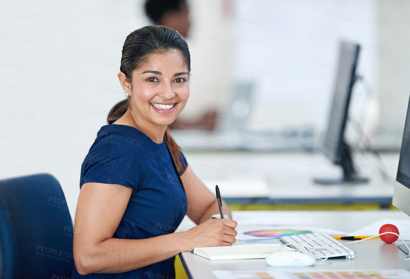 Buy stock photo Portrait of an attractive young designer sitting at her desk working on a computer