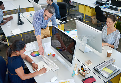 Buy stock photo High angle shot of a group of designers working at their computers in an office