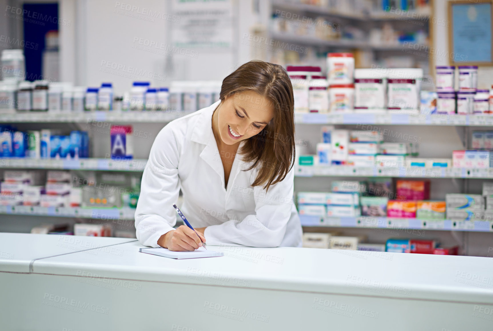 Buy stock photo Woman, pharmacist and smile at counter with writing, prescription order and planning in pharmacy. Specialist, chemist and notepad with pen for medical information, report and inventory management