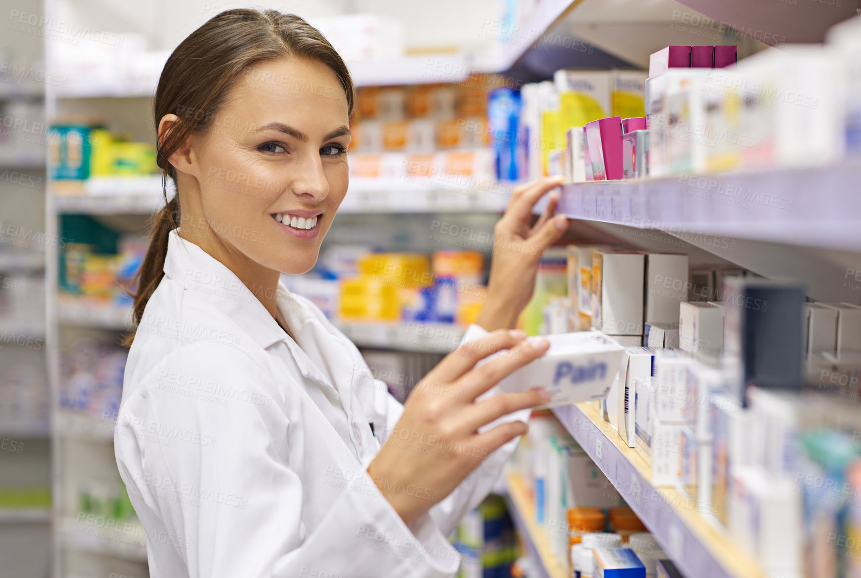 Buy stock photo Woman, happy and pharmacist on shelf at drug store with pride for customer service. Female person, portrait and smile or satisfied with confidence at pharmacy for medication and prescription