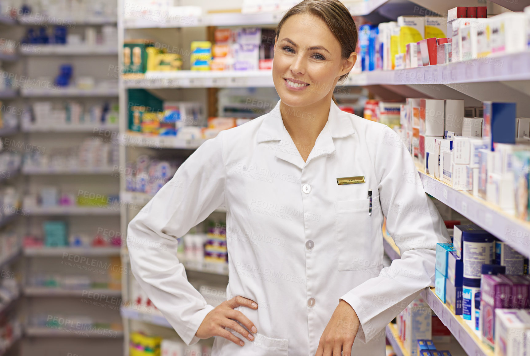 Buy stock photo Portrait of an attractive young pharmacist standing in an aisle