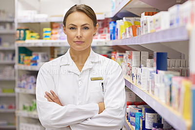 Buy stock photo Portrait of an attractive young pharmacist standing in an aisle