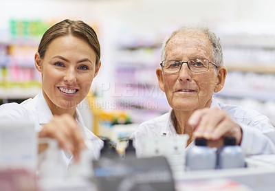 Buy stock photo Portrait of a young pharmacist helping an elderly customer