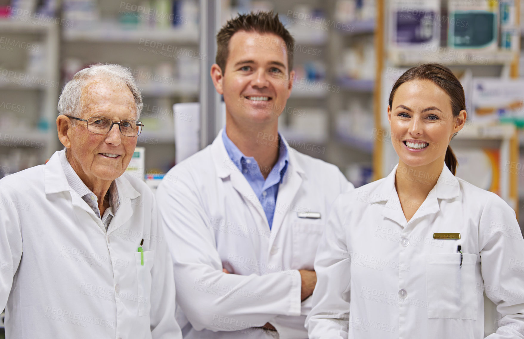 Buy stock photo Portrait of  three pharmacists standing at a counter