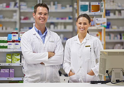 Buy stock photo Portrait of  two pharmacists standing at a counter