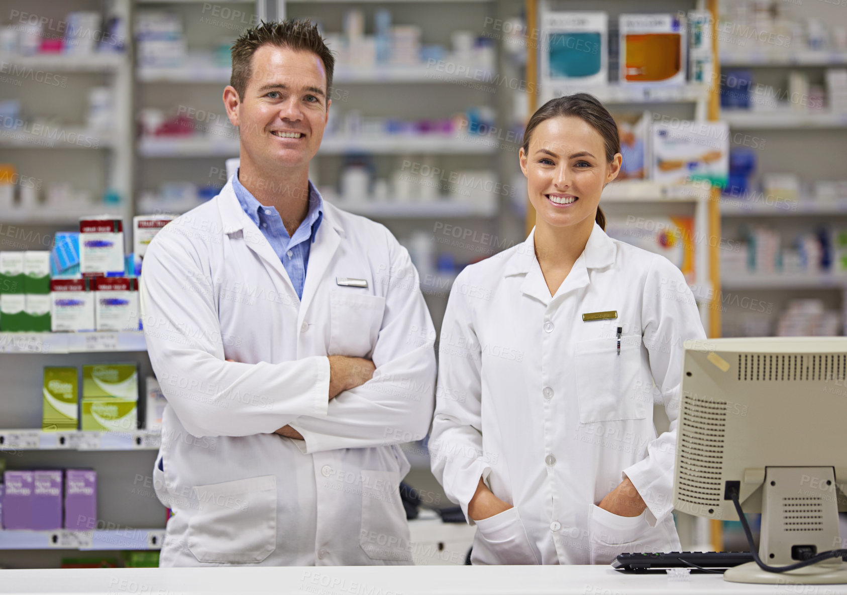 Buy stock photo Portrait of  two pharmacists standing at a counter