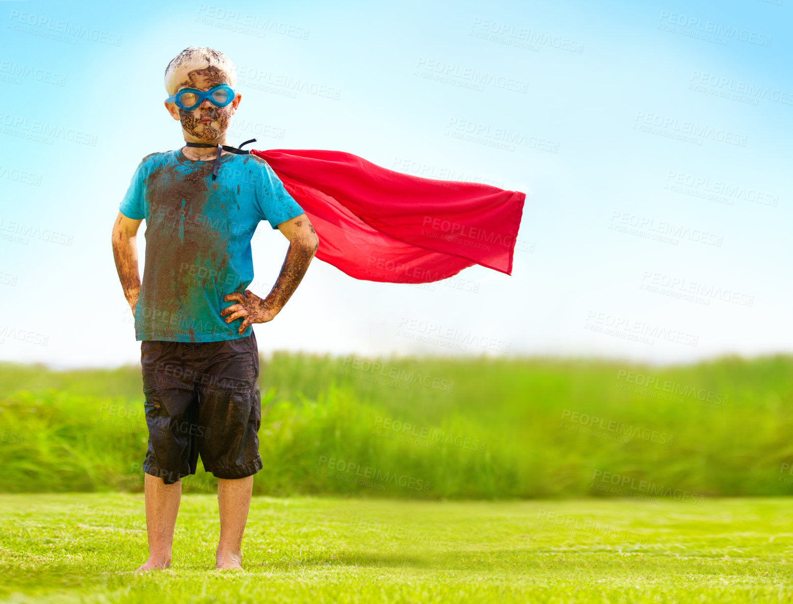 Buy stock photo Portrait, confident and superhero kid outdoor with wind on cape, goggles and mockup on blue sky. Boy, child and hero in costume at garden in dirty clothes, mud or messy for fantasy in Sweden at grass