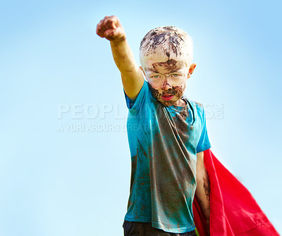 Buy stock photo Dirt, mud and portrait of child with superhero costume, fist and confidence playing outside confident on blue background. Boy, freedom and fun outdoor for role play, pretend and serious in youth