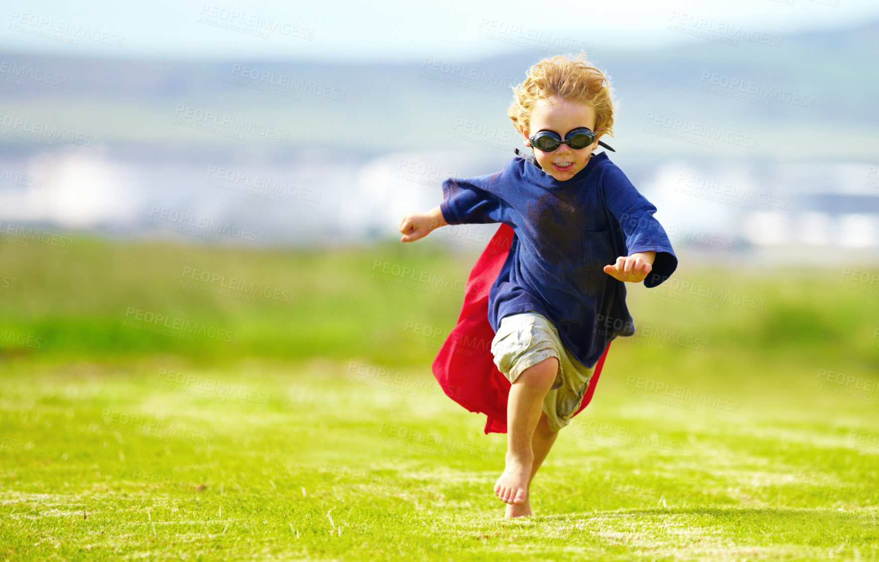Buy stock photo Young boy, costume and running in park, playing and carefree outdoor with happiness or playful child on grass. Freedom, energy or youth and happy kid in cape or goggles fun on green lawn with mockup
