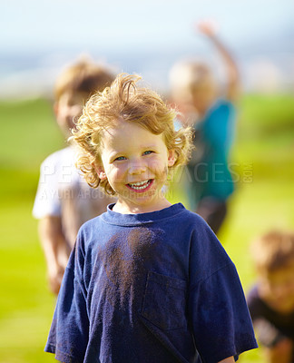 Buy stock photo Dirt, smile and face of child for games by grass, lawn and outdoor playing outside with happiness in nature. Boy, freedom or fun childhood for activity, comic and excited in youth with friends
