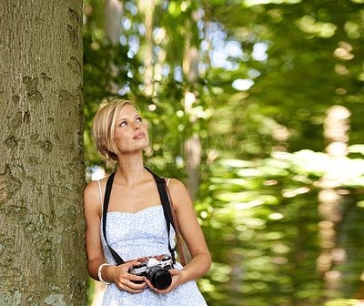 Buy stock photo Thinking, trees and photography with woman in forest for relax, memory and travel photography. Summer, nature and adventure with person and camera for vacation, holiday and environmental tourism