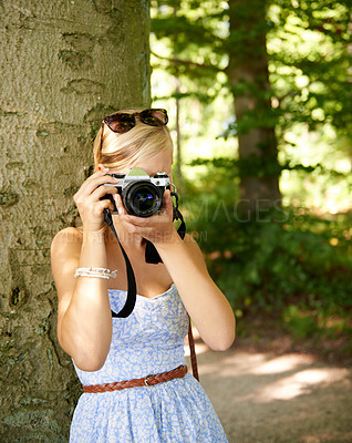Buy stock photo Camera lens, nature and photographer with woman in forest for relax, memory and travel photography. Summer, trees and adventure with female person for vacation, holiday and environmental tourism