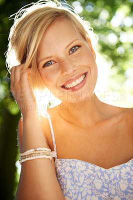 Buy stock photo Portrait of a beautiful young woman standing in a sunlit forest