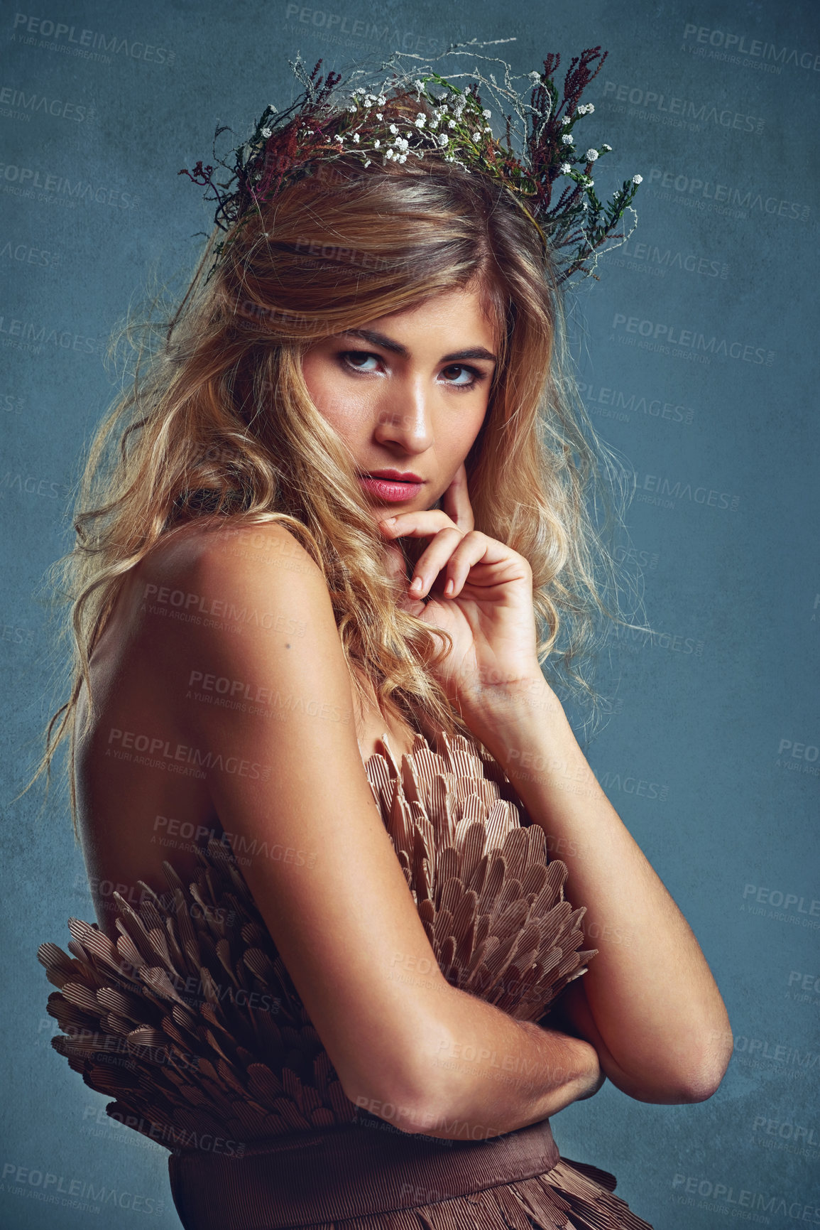 Buy stock photo Portrait, beauty and woman with flower crown for fashion in studio isolated on blue a background. Face, wreath and  confident person in makeup for skin, hair or natural cosmetics with body in dress
